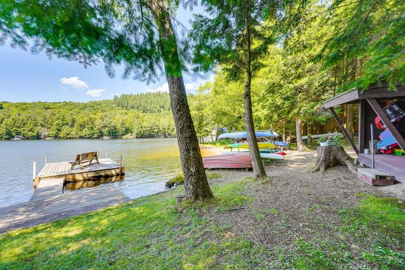 Swim dock and kayaks under the hemlocks